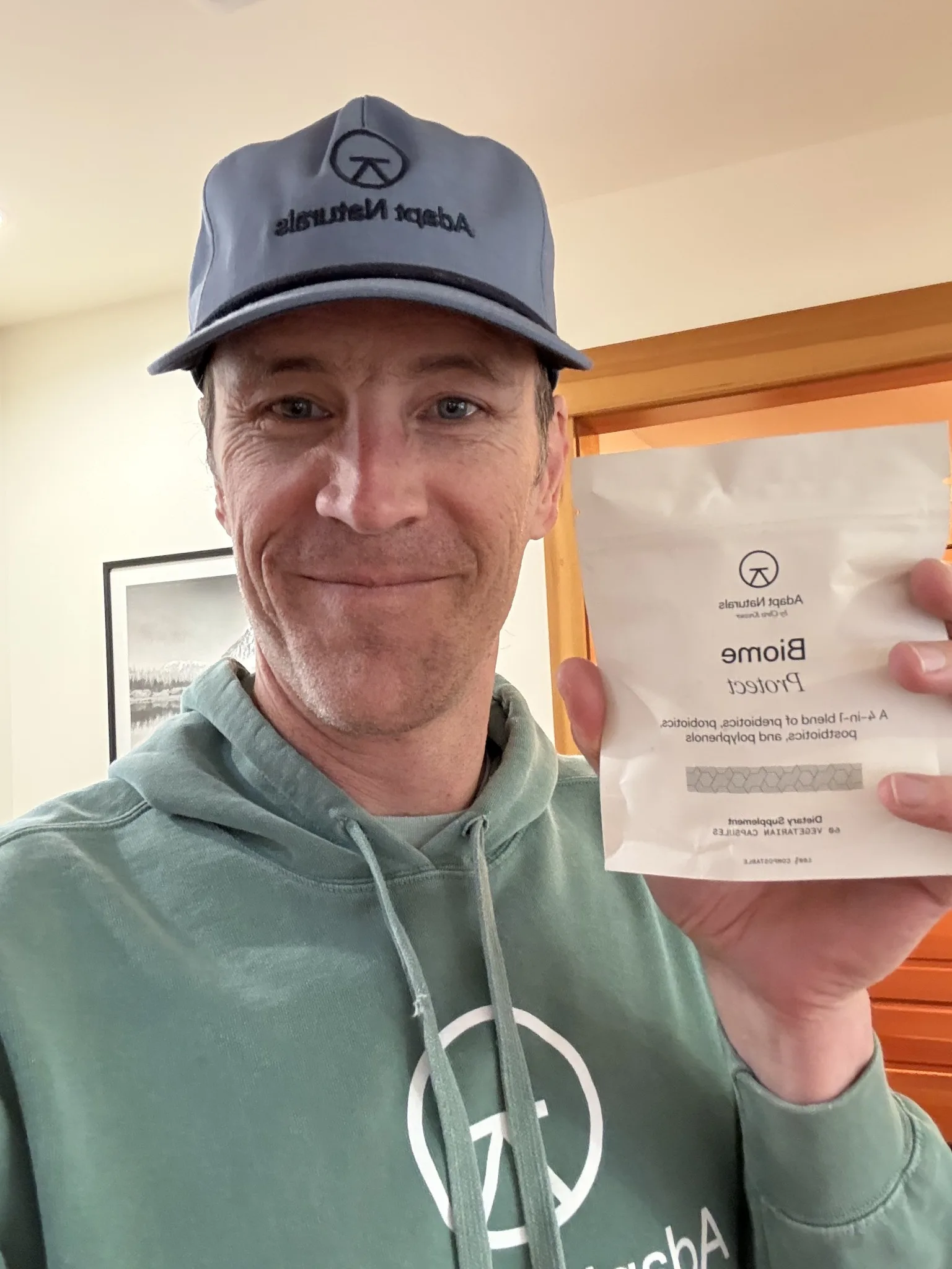 Chris Kresser holding an Adapt Naturals supplement pouch